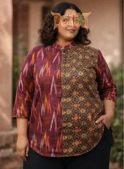 Woman wearing Boriby plus size shirt with maroon ikat and earthy geometric patterns, mandarin collar, button‑down front, outdoor background.