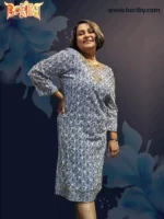 A woman wearing a knee‑length black and white patterned cotton dress with gold embroidery on the neckline, cuffs, and hem, designed by Boriby.