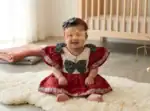 Infant girls red and white bow dress close‑up of bow detail