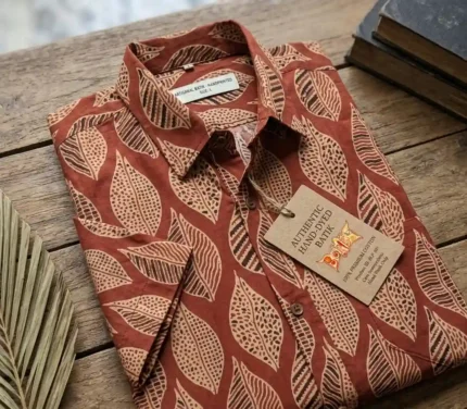 Folded Boriby Ajrakh Printed Half Shirt with artisan motifs on wooden surface