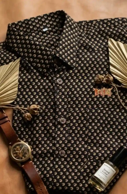 Black Boriby Ajrakh Printed Half Shirt with beige motifs styled with watch, perfume, and palm leaves in flat lay