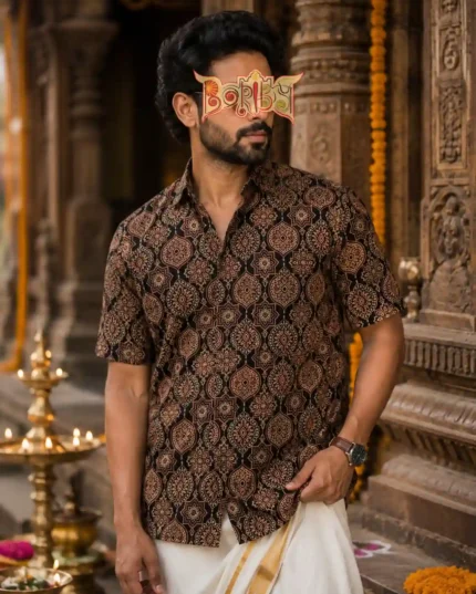 Man in Ajrakh printed half shirt with dhoti in ornate heritage backdrop
