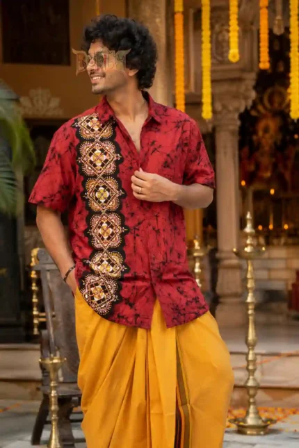 XL men’s handmade batik half shirt with red and black patterns, paired with yellow dhoti in festive setting